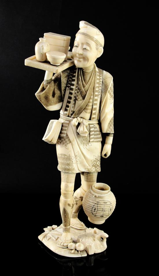 A large Japanese sectional walrus ivory figure of a man, early 20th century, 32cm
